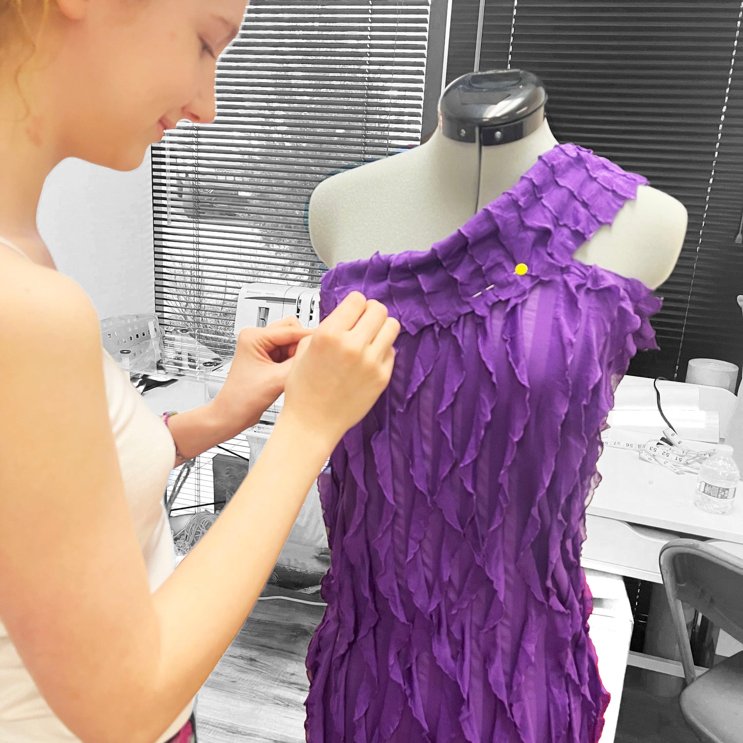 a student from advanced clothing design class is drapering her beautiful dress