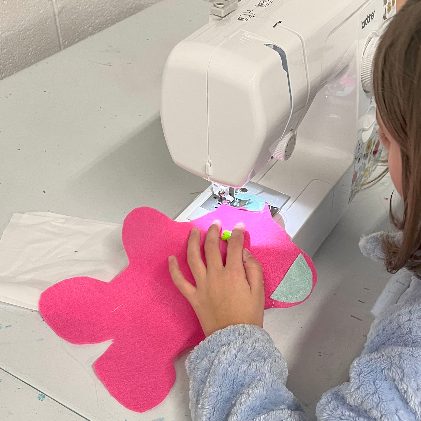 A girl is sewing a Taddy Bear from Intermediate Digital Sewing Class for Kids Self-Paced Video Tutorials