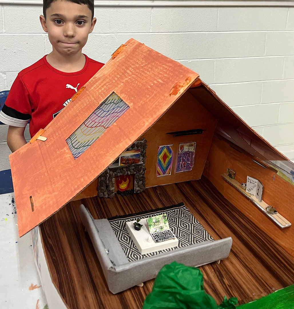 Proud Young Architects student showing his modern house interior design model created in our kids architecture and interior design program in Schaumburg