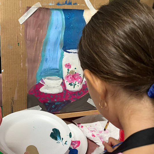 a girl from our classes painting and drawing program is working on her still live project